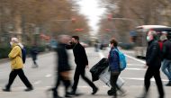 Pedestrians wearing face masks cross a street in the city center, during the coronavirus disease (COVID-19) outbreak, in Barcelona, Spain, January 18, 2021. REUTERS/Albert Gea
