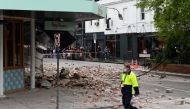 A person walks past damage to the exterior of a restaurant following an earthquake in the Windsor suburb of Melbourne, Australia, September 22, 2021. AAP Image/James Ross via REUTERS