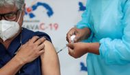 FILE PHOTO: A Panamanian health worker receives the second shot of the Pfizer-BioNTech COVID-19 vaccine at the Santo Tomas Hospital, in Panama City, Panama February 17, 2021. REUTERS/Erick Marciscano/File Photo
