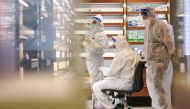 Members of a cleaning crew wearing personal protective equipment (PPE) work inside a closed shop in the city centre during a lockdown to curb the spread of a coronavirus disease (COVID-19) outbreak in Sydney, Australia, September 24, 2021. REUTERS/Loren E