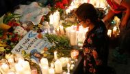 A placard is seen among flowers and candles during a vigil in memory of Sabina Nessa, a teacher who was murdered in Pegler Square, in London, Britain September 24, 2021. Reuters/Peter Nicholls
