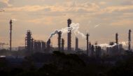 File photo: Birds and a plane are seen flying above emission from the chimneys of a chemical plant located near Port Botany in Sydney, Australia June 2, 2017. Reuters/David Gray/File Photo
