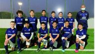 PSG Academy U-12 team players with an official.