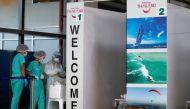 Health workers stand at the COVID-19 swab test area at the airport as Phuket reopens to overseas tourists, allowing foreigners fully vaccinated against the coronavirus disease (COVID-19) to visit the resort island without quarantine, in Phuket, Thailand J