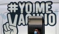 FILE PHOTO: A man waits outside a mobile vaccination centre to receive a dose of Sinovac's CoronaVac coronavirus disease (COVID-19) vaccine in Santiago, Chile May 24, 2021. The sign reads ''I get vaccinated