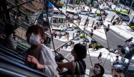 People wearing protective masks are reflected in the mirror at a shopping mall in Tokyo amid the coronavirus disease (COVID-19) outbreak in Tokyo, Japan, August 19, 2021. REUTERS/Athit Perawongmetha/File Photo