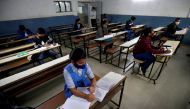 Students wearing protective face masks attend their class as they maintain social distancing after authorities reopened schools for classes for 10 and 12 after the schools were closed for months due to the coronavirus disease (COVID-19) outbreak, in Ahmed