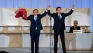 Former Japanese Foreign Minister Fumio Kishida celebrates with outgoing Prime Minister, Yoshihide Suga, after being announced the winner of the Liberal Democrat Party leadership election in Tokyo, Japan September 29, 2021. Carl Court/Pool via Reuters
