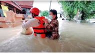 A rescuer uses a rope to carry a victim across flood waters in the Chaiyaphum province, Thailand, in this screen grab taken from a video from social media September 28, 2021. Picture taken September 28, 2021. Hook31 Thailand/via REUTERS