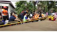 Flood victims sit on a boat after they were rescued amid severe flooding in the Chaiyaphum province, Thailand, in this screen grab taken from a video from social media September 28, 2021. Hook31 Thailand/via Reuters 
