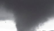 Debris fly around a tornado funnel in Bathurst, New South Wales, Australia September 30, 2021. Dean Whiting via REUTERS