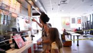 Naomi and Lydia Hassebroek order food from Taco Bell during the outbreak of the coronavirus disease (COVID-19) in Brooklyn, New York, U.S., June 23, 2020. REUTERS/Caitlin Ochs/File Photo