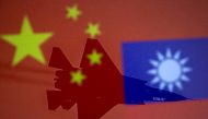 File photo: Chinese and Taiwanese national flags are displayed alongside a military airplane in this illustration taken April 9, 2021. Reuters/Dado Ruvic/Illustration/File Photo
 