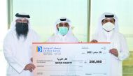 Officials from Doha Bank and Qatar Charity during the bank’s presentation of its QR200,000 cash donation, in Doha, recently. 