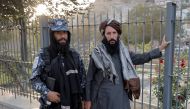 Members of Taliban forces, of which one is armed, pose at a check point after several civilians were killed in an explosion, in Kabul, Afghanistan October 3, 2021. Reuters/Jorge Silva