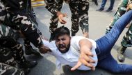 Police forces detain a man during a protest by activists of the youth wing of India's main opposition Congress party outside UP Bhawan, after people were killed when violence broke out in Uttar Pradesh state on Sunday, in New Delhi, India, October 4, 2021