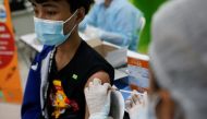 A high school student receives the Pfizer vaccine for the coronavirus disease (COVID-19) ahead of schools reopening in November, at a school in Bangkok, Thailand, October 4, 2021. REUTERS/Soe Zeya Tun