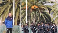 Qatar coach Felix Sanchez (left) and Qatar players take part in a training session.