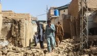 Residents walk amid the rubble of damaged houses along a street following an earthquake in Harnai, Balochistan, Pakistan, October 7, 2021. Reuters/Naseer Ahmed
