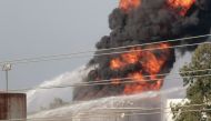 Water is sprayed at a fire in the Zahrani oil facility in southern Lebanon, October 11, 2021. Reuters/Ali Hankir 