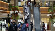 People wearing protective face masks walk at the Pondok Indah shopping mall, as the Indonesian capital reopens shopping malls with a new policy requiring shoppers to show a coronavirus disease (COVID-19) vaccination certificate, in Jakarta, Indonesia, Aug