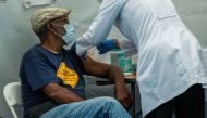 FILE PHOTO: A person receives a dose of the Pfizer-BioNTech vaccine for the coronavirus disease (COVID-19) as New York State Governor Kathy Hochul speaks during a news conference about the coronavirus disease (COVID-19) vaccination mandate for healthcare 