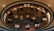 Shoppers sit at tables inside Westfield Bondi Junction as businesses re-open to vaccinated patrons in the wake of coronavirus disease (COVID-19) regulations easing, following months of lockdown orders to curb an outbreak of cases, in Sydney, Australia, Oc