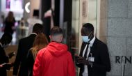 A person has his Green Pass checked as the health pass becomes mandatory in the workplaces across Italy, at La Rinascente mall, in Rome, Italy, October 15, 2021. REUTERS/ Yara Nardi