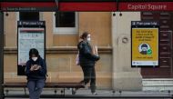 People wear protective face masks in the city centre during a lockdown to curb the spread of a coronavirus disease (COVID-19) outbreak in Sydney, Australia, September 28, 2021. REUTERS/Loren Elliott