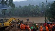 Rescue workers carry the body of a victim after recovering it from the debris of a residential house following a landslide caused by heavy rainfall at Kokkayar village in Idukki district in the southern state of Kerala, India, October 17, 2021. REUTERS/St