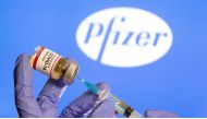 FILE PHOTO: A woman holds a small bottle labeled with a 