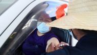 A member of the public receives a Pfizer vaccine at a drive-through coronavirus disease (COVID-19) vaccination clinic in Otara during a single-day vaccination drive, aimed at significantly increasing the percentage of vaccinated people in the country, in 