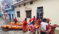 Members of National Disaster Response Force (NDRF) evacuate people to safer places from a flooded area in Udham Singh Nagar in the northern state of Uttarakhand, India, October 19, 2021. National Disaster Response Force/Handout via REUTERS