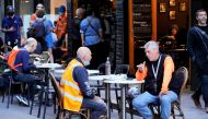 Diners eat outside at a cafe on the first day of eased coronavirus disease (COVID-19) regulations, following a lockdown to curb an outbreak, in Melbourne, Australia, October 22, 2021. REUTERS/Sandra Sanders
