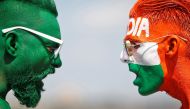 Cricket fans, with their faces painted in the Indian and Pakistani national flag colours, pose for a picture ahead of the first match between India and Pakistan in Twenty20 World Cup super 12 stage in Dubai, in Ahmedabad, India, October 23, 2021. Reuters/