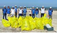 Employees from Jaidah Motors during a drive to clean Abu Zalub beach organised by General Cleanliness Department.