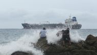 People are pictured on a beach as tropical Storm Rick strengthened into a hurricane off Mexico's Pacific coast, in Acapulco, Mexico October 23, 2021. REUTERS/Javier Verdin
