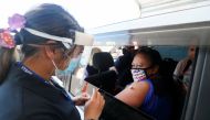 A member of the public receives a Pfizer vaccine at a drive-through coronavirus disease (COVID-19) vaccination clinic in Otara during a single-day vaccination drive, aimed at significantly increasing the percentage of vaccinated people in the country, in 