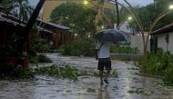 A man walks along a flooded street after Hurricane Rick hit in Zihuatanejo, in Guerrero state, Mexico October 25, 2021. REUTERS/Javier Verdin
