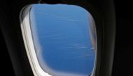 Drifting pumice stones, apparently from the eruption of an undersea volcano, are seen on the sea through the window of a commercial flight off the southern island of Okinawa, Okinawa prefecture, Japan, October 27, 2021. REUTERS/Issei Kato