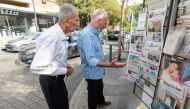 People read newspaper headlines announcing Saudi's decision at a kiosk in Beirut, Lebanon, October 30, 2021. (REUTERS/Aziz Taher)