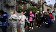 People line up outside a vaccination site after the city started offering booster shots of the vaccine against the coronavirus disease (COVID-19) to vaccinated residents, in Beijing, China October 29, 2021. (REUTERS/Tingshu Wang)