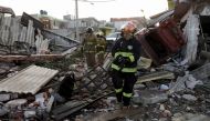 Firefighters walk at an area affected by the explosion of a gas leak caused by a pipeline theft, in the San Pablo Xochimehuacan neighborhood in Puebla, Mexico October 31, 2021. REUTERS/Imelda Medina