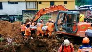Colombian Civil Defense workers unearth the body of a deceased person in a landslide that was caused by heavy rains in the country, in Mallana, Colombia November 2, 2021. Colombian Civil Defense/Handout via REUTERS