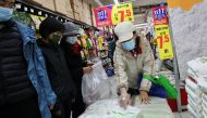People buy bags of rice at a supermarket following outbreak of the coronavirus disease (COVID-19) in Beijing, China, November 3, 2021. REUTERS/Thomas Peter
