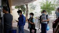 People queue up at a community vaccination centre to receive a dose of the Sinovac Biotech coronavirus disease (COVID-19) vaccine in Hong Kong, China, February 26, 2021. REUTERS/Tyrone Siu