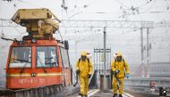Specialists wearing personal protective equipment (PPE) spray disinfectant while sanitizing the Kazansky railway station amid the outbreak of the coronavirus disease (COVID-19) in Moscow, Russia November 2, 2021. REUTERS/Maxim Shemetov


