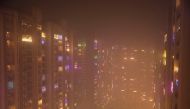 Lights decorating the balconies of a high-rise are seen shrouded in smog in Noida, India, November 5, 2021. Reuters/Anushree Fadnavis