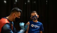 Dr. Mayank Amin administers the Pfizer-BioNTech coronavirus disease (COVID-19) vaccine to Evan Schuster, 7, in Collegeville, Pennsylvania, U.S., November 6, 2021. (REUTERS/Hannah Beier )
