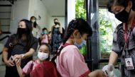 Children wearing protective face masks sanitise their hands as they attend preschool classes at St James' Church Kindergarten as schools reopen amid the coronavirus disease (COVID-19) outbreak in Singapore June 2, 2020. REUTERS/Edgar Su